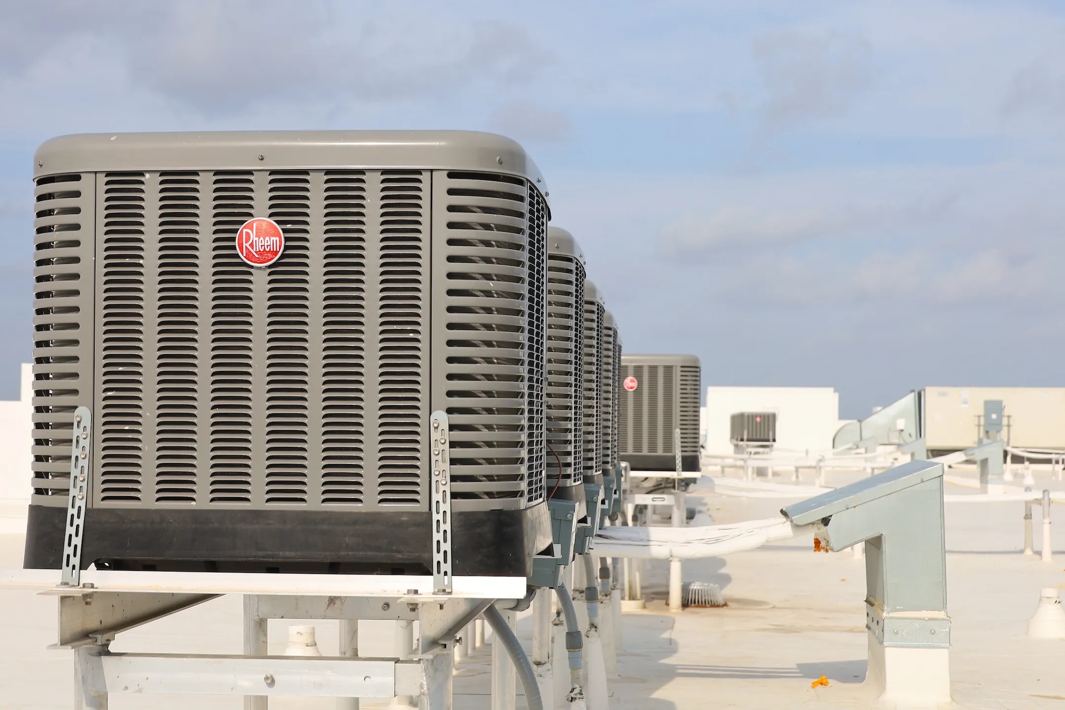 Rheem condensors sit on a mid-rise building roof in West Palm Beach